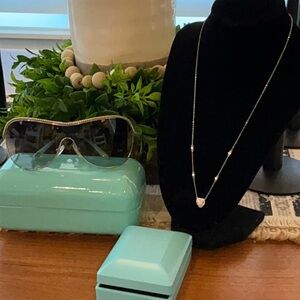Tiffany and Co. Bundle sunglasses with a rhinestone heart necklace